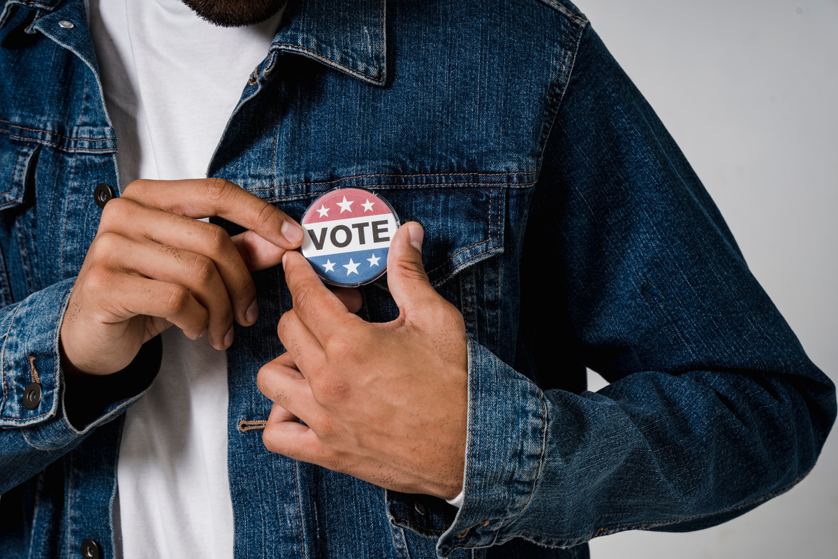 A Person Wearing a Denim Jacket with Pin Back Button